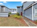 Exterior view of a well maintained blue sided two-story townhouse at 140 Coco Plum, Davenport, FL 33897