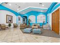Inviting lobby area featuring tile floors, comfortable seating, and bright turquoise accents at 140 Coco Plum, Davenport, FL 33897