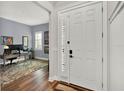 View of entryway featuring a white front door that leads to a well-lit home office at 15245 Blue Peacock Ln, Winter Garden, FL 34787