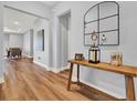 Inviting foyer with beautiful hardwood floors, a wooden table, and stylish decor at 15245 Blue Peacock Ln, Winter Garden, FL 34787