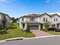 Attractive two-story home with landscaped front yard, brick driveway, and attached garage in a Gathering-friendly community at 2052 Milkweed St, Ocoee, FL 34761