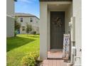 Charming front entrance featuring a wreath and a seasonal Harvest decoration at 2052 Milkweed St, Ocoee, FL 34761