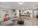 Cozy living space flowing into a modern kitchen with stainless appliances and barstool seating at 2052 Milkweed St, Ocoee, FL 34761