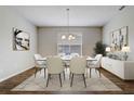 Bright dining room with stylish chandelier, white table and chairs, artwork and plants at 2282 Kaley Ridge Rd, Clermont, FL 34715