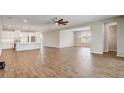Open concept living area featuring wood-look tile floors, a modern kitchen with a breakfast bar, and spacious layout at 2282 Kaley Ridge Rd, Clermont, FL 34715