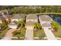 Aerial view of a home featuring mature landscaping in a neighborhood close to a pond at 2613 Santosh Cv, Kissimmee, FL 34746
