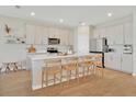 Modern kitchen features white cabinets, quartz countertops, and stainless steel appliances at 2714 Forestdale St, St Cloud, FL 34771