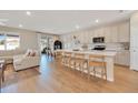 Bright open kitchen with white cabinetry, a large island, and wood-look flooring at 2714 Forestdale St, St Cloud, FL 34771
