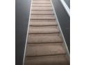 Carpeted stairs leading to the upper level, featuring a neutral color palette at 2763 Metro Sevilla Dr # 108, Orlando, FL 32835