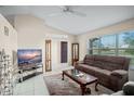 Bright living room with tile flooring, a large window, and comfortable seating at 2769 E Dorchester Dr, Deltona, FL 32738