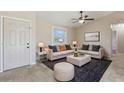 Cozy living room with neutral tones, featuring comfortable seating, a ceiling fan, and ample natural light at 2801 W Covington Dr, Deltona, FL 32738