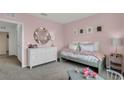 Stylish pink bedroom featuring elegant decor and a comfortable bed with decorative pillows at 3089 Tobago, Haines City, FL 33844