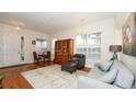Bright living room with hardwood floors, comfortable seating, and a large window at 4527 Sunset Ln, Oviedo, FL 32765