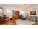 Bright living room showcasing hardwood floors, large windows, a stylish area rug, and comfortable seating arrangements at 4527 Sunset Ln, Oviedo, FL 32765