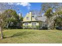 Charming two-story home with a well-maintained lawn, mature trees, and classic architecture at 501 Sheridan Blvd, Orlando, FL 32804