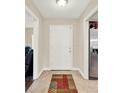 Inviting foyer features neutral walls and a colorful welcome mat at 5715 Satel Dr, Orlando, FL 32810