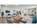 Bright, open-concept living space with modern furnishings and an adjacent kitchen and dining area at 656 Marion Oaks Mnr, Ocala, FL 34473
