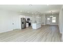 Bright, open kitchen with stainless steel appliances, a center island, and sleek white cabinets at 656 Marion Oaks Mnr, Ocala, FL 34473