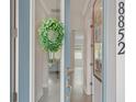 Bright entryway featuring a glass door with green wreath and wood laminate flooring at 8852 Sperry St, Orlando, FL 32827