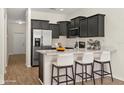 Modern kitchen with stainless steel appliances, quartz countertops, and breakfast bar seating at 10608 Savannah Plantation Ct, Orlando, FL 32832