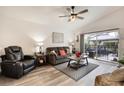 Cozy living room featuring a ceiling fan and sliding glass doors to the patio at 130 Bloomingdale Dr, Davenport, FL 33897