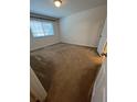 Cozy bedroom with neutral carpeting and a window providing natural light, creating a comfortable space at 1309 Heritage Commons Dr, Winter Springs, FL 32708