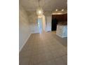 Open dining area features a modern chandelier and tiled flooring adjacent to the kitchen and entry hall at 1309 Heritage Commons Dr, Winter Springs, FL 32708