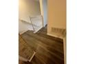 Hallway with wood-look flooring and white trim leads to different areas of the home at 1309 Heritage Commons Dr, Winter Springs, FL 32708