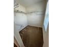 Spacious walk-in closet with shelving, a window, and carpet, offering ample storage at 1309 Heritage Commons Dr, Winter Springs, FL 32708