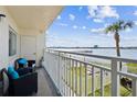 Balcony with seating features serene water views and glimpses of lush community green space at 145 N Halifax Ave # 211, Daytona Beach, FL 32118