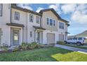 Charming two-story townhome features a one car garage and landscaped front yard at 1620 Pelican Dr, Davenport, FL 33896