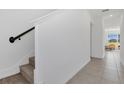 Hallway and stairway feature tiled floors and a light-filled entryway at 1620 Pelican Dr, Davenport, FL 33896
