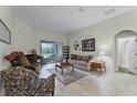 Inviting living room with tile floors, comfortable seating, and natural light from sliding glass doors at 2829 Autumn Breeze Way, Kissimmee, FL 34744
