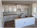 Bright kitchen with white cabinets, providing ample storage space for all your culinary needs at 3165 Cup Dr, Lakeland, FL 33803