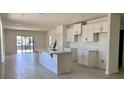 Open kitchen with white cabinetry, large island, stainless steel faucet, and lots of light at 3225 Cup Dr, Lakeland, FL 33803