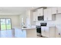 Modern kitchen with white cabinets, stainless steel appliances, and a kitchen island at 3225 Cup Dr, Lakeland, FL 33803