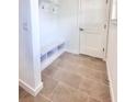 Bright mudroom featuring tile flooring, built-in shelving, and a convenient bench at 3225 Cup Dr, Lakeland, FL 33803