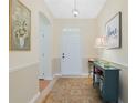 Welcoming entryway with decorative rug and stylish console table at 325 Bellingrath Terrace, Deland, FL 32724