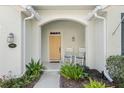 Inviting front porch featuring rocking chairs and decorative plants at 325 Bellingrath Terrace, Deland, FL 32724