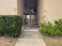 Exterior view of a condo building with a walkway and stairs to the upper level units at 370 N Windmeadows St # 370, Altamonte Springs, FL 32701