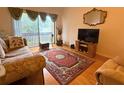 Cozy living room featuring a large window and hardwood flooring at 370 N Windmeadows St # 370, Altamonte Springs, FL 32701