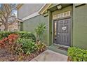 Charming front entrance with lush landscaping and a welcoming dark colored door at 466 Ashley Brooke Ct # C, Apopka, FL 32712