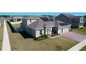 Well-maintained home featuring solar panels and a lush green lawn at 4897 Gilded Jewel Dr, Mount Dora, FL 32757