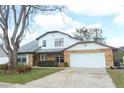 Spacious two-story home featuring a two-car garage and a well-manicured front yard at 5136 Stratemeyer Dr, Orlando, FL 32839