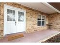 Inviting front porch with double doors, brick accents, and a welcoming doormat at 5136 Stratemeyer Dr, Orlando, FL 32839