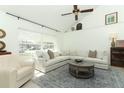 Bright living room with high ceilings, large windows, and stylish furnishings at 5136 Stratemeyer Dr, Orlando, FL 32839