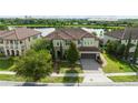 Charming two-story home featuring a tile roof, manicured lawn and two-car garage at 8231 Chilton Dr, Orlando, FL 32836
