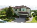 An eye-level view of a two-story home with a paver driveway and manicured landscaping at 8231 Chilton Dr, Orlando, FL 32836