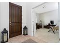 Inviting home foyer featuring a dark wood front door and a glimpse of a bright office at 8231 Chilton Dr, Orlando, FL 32836