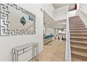 Inviting foyer with a staircase, modern decor, and open views of the living space at 9026 Rhodes St, Kissimmee, FL 34747